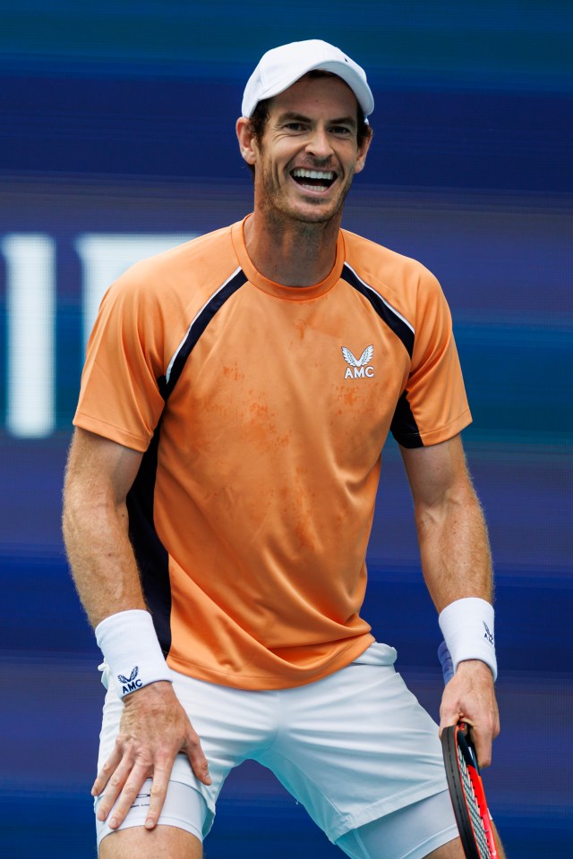 Andy Murray laughing after missing a tennis shot.
