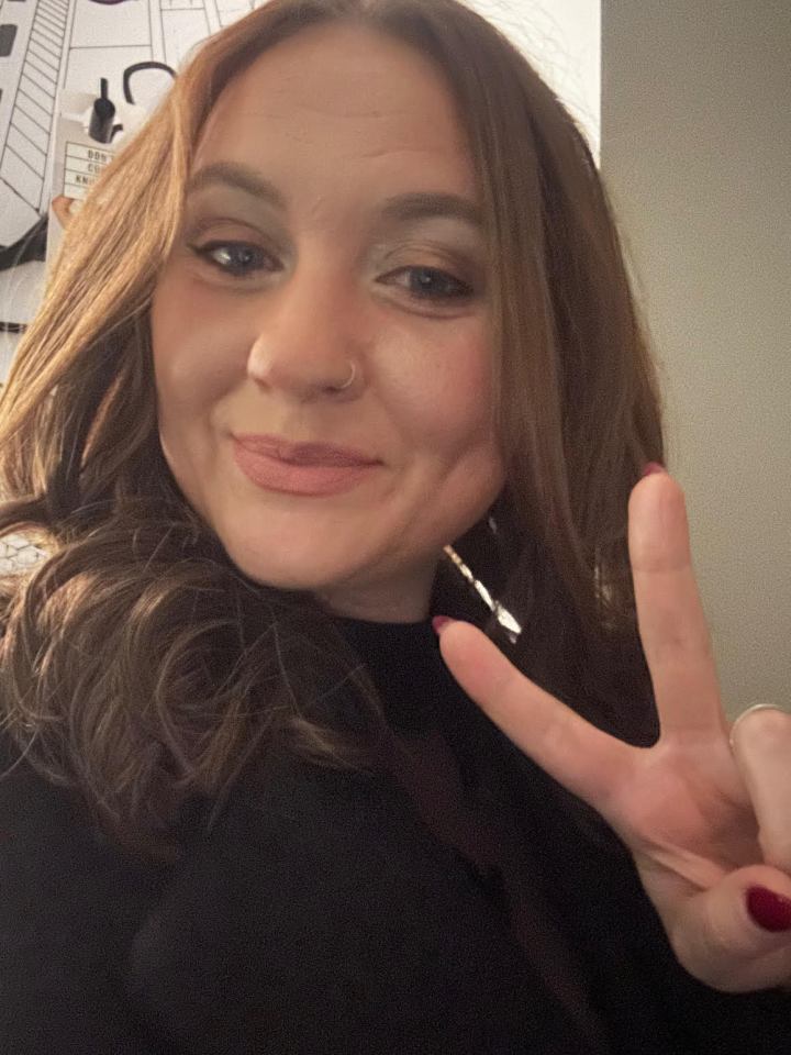 Woman giving peace sign.