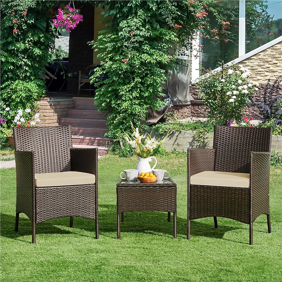 Brown wicker patio set with two chairs and a small table.