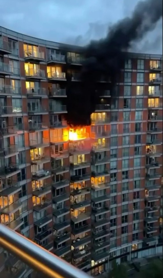 Large fire engulfing a section of an apartment building.