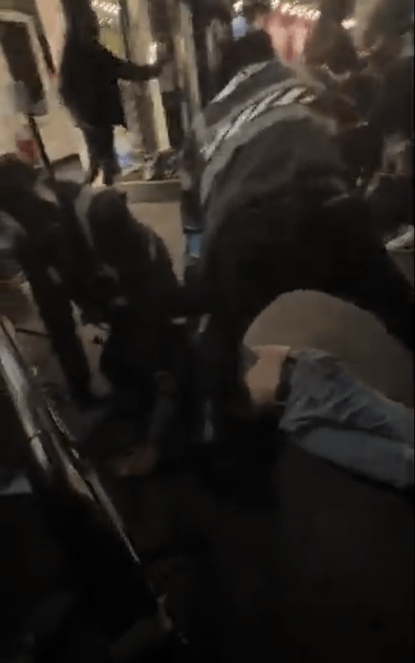 A bouncer being punched during a bar brawl.