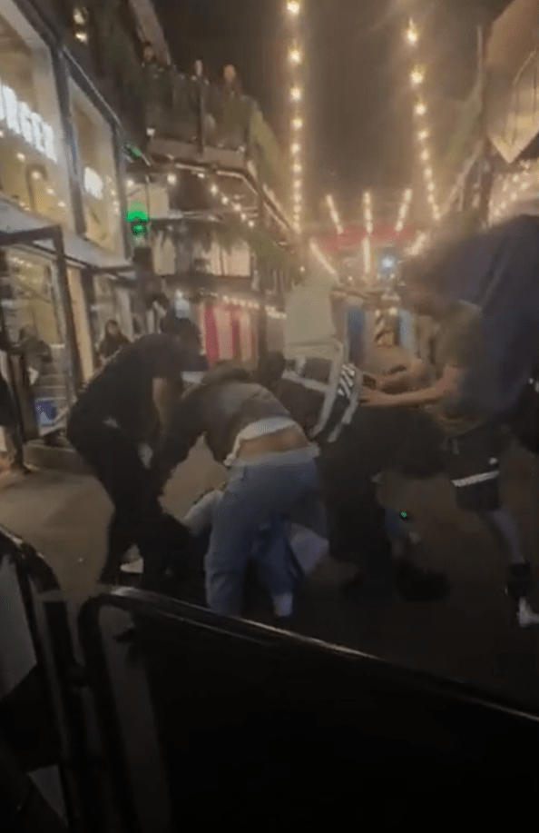A bouncer being punched during a bar brawl.