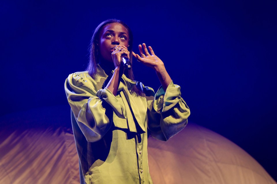 Cat Burns performing on stage.