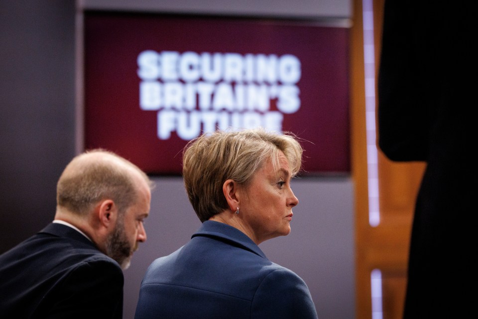 Yvette Cooper listening to a speech about Britain's immigration policy.