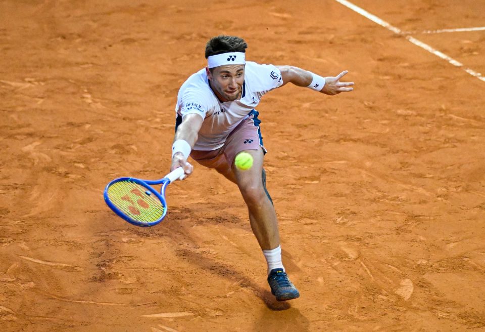 Casper Ruud of Norway playing a forehand in a tennis match.