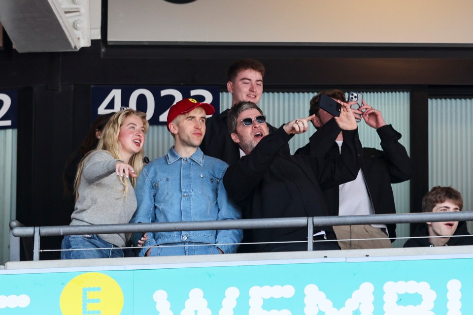 Noel Gallagher and family at a soccer match.
