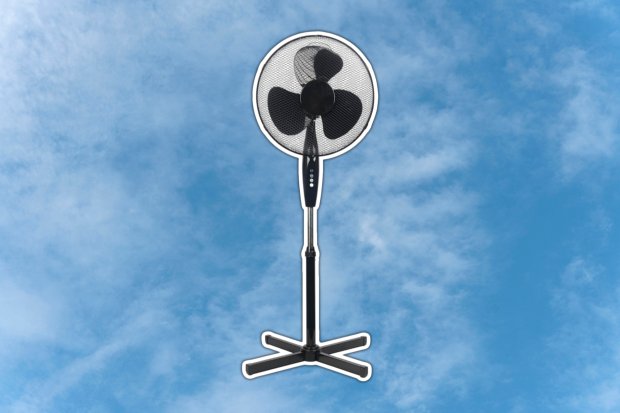 Pedestal fan against a blue sky.