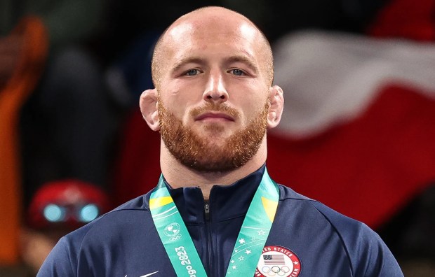 Kyle Snyder of Team USA on a podium with a gold medal.