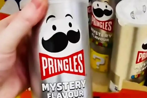 Hand holding a can of Pringles Super Mario Mystery Flavor.