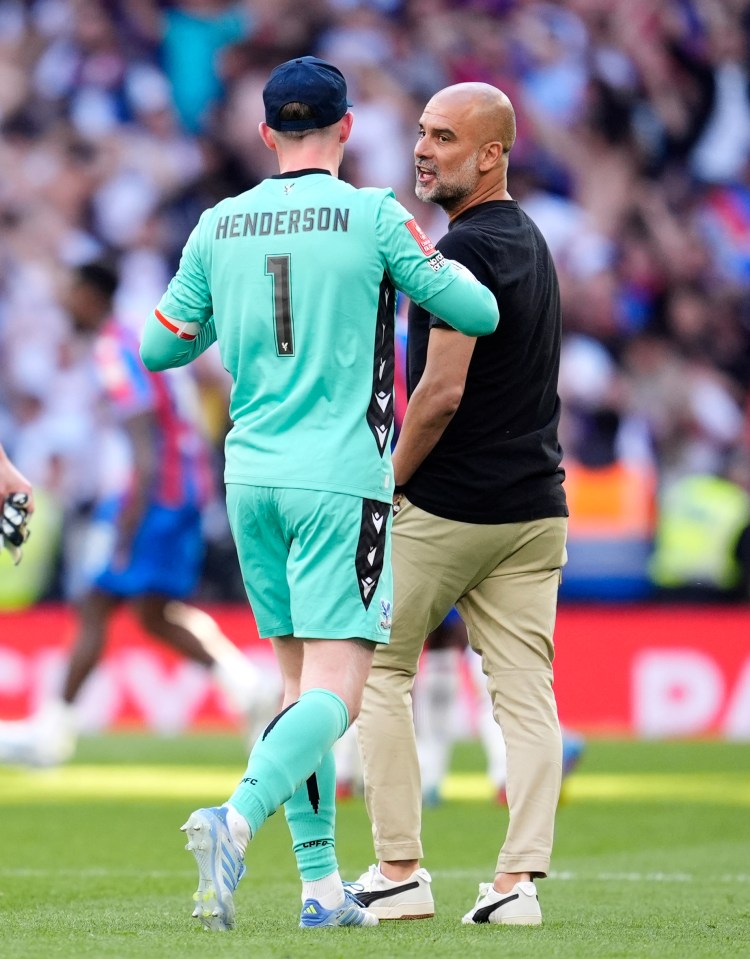 Dean Henderson and Pep Guardiola talking on a soccer field.
