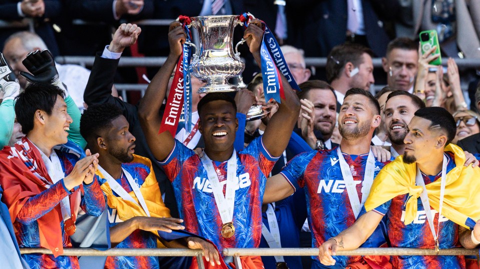 Crystal Palace players celebrate with the FA Cup trophy.