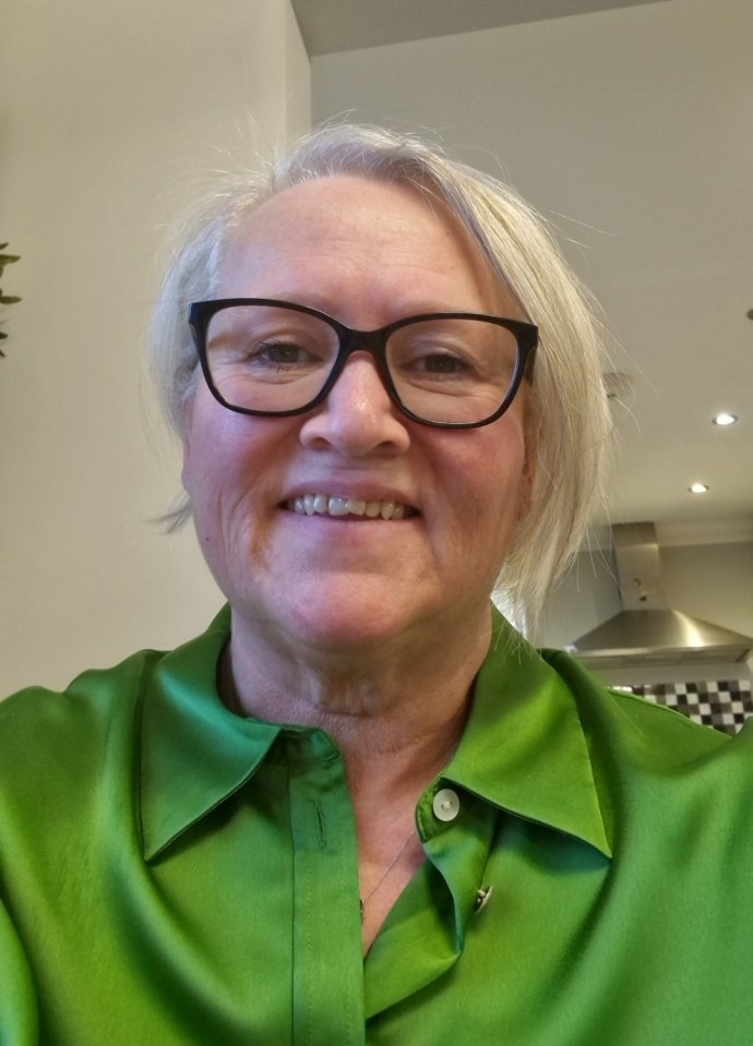 Woman in green shirt and glasses.