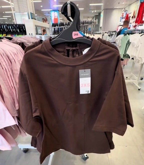 Brown cinch-waist T-shirt on display in Primark.