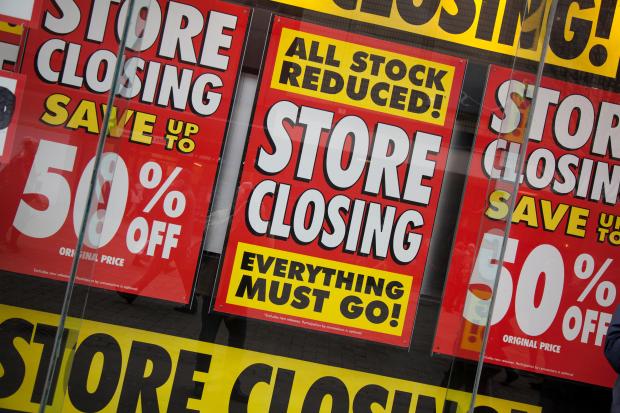 Store closing sale signs advertising 50% off.