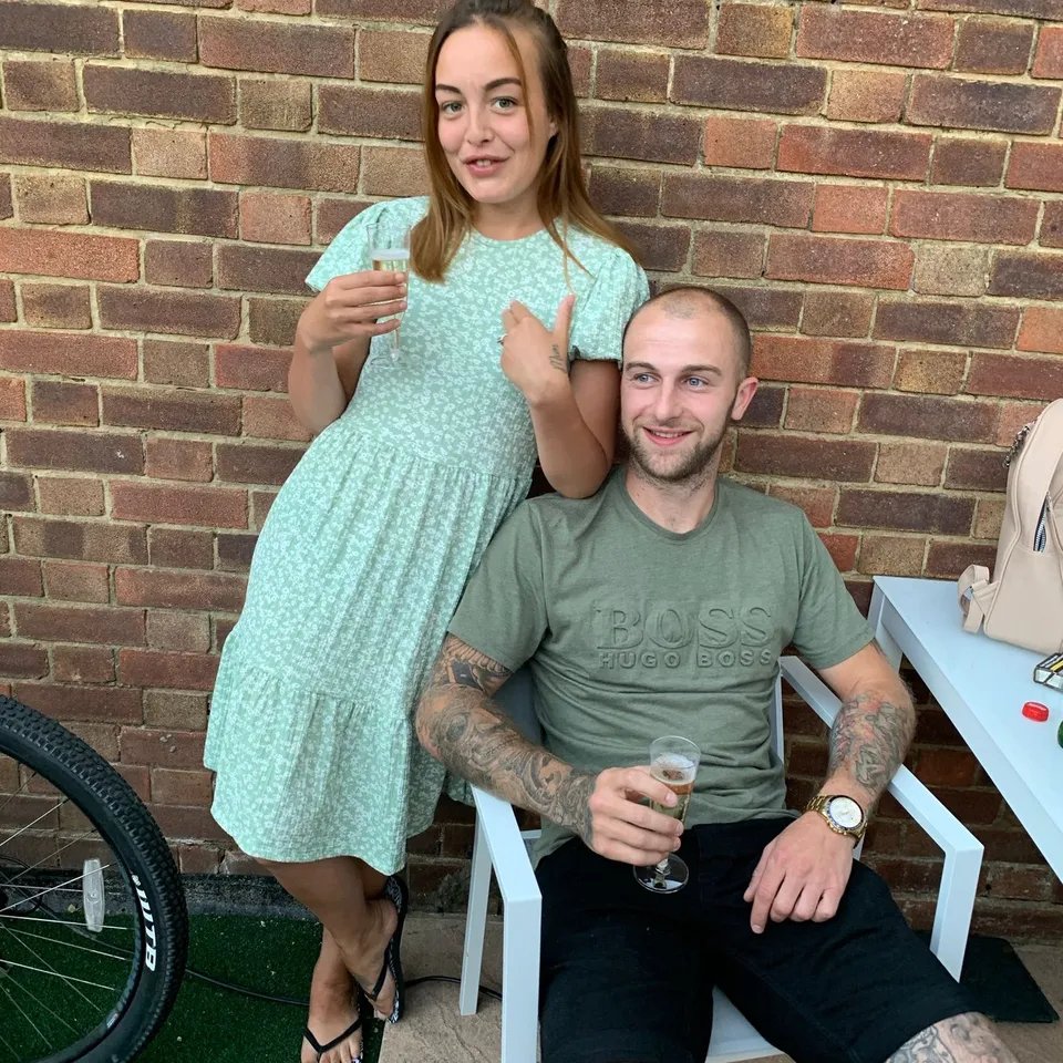 Photo of a man and woman holding drinks.