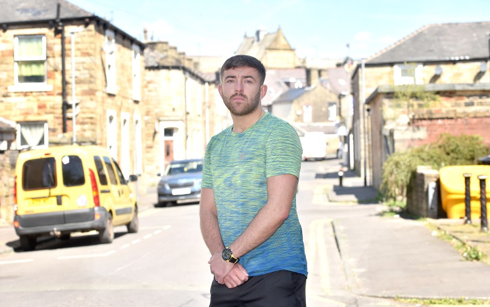 Man leaning against a fence.