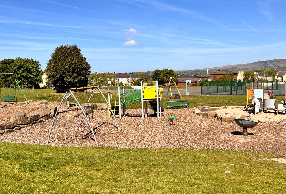 Playground with swings, slides, and other play equipment.