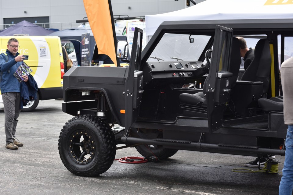 Black electric off-road vehicle on display.