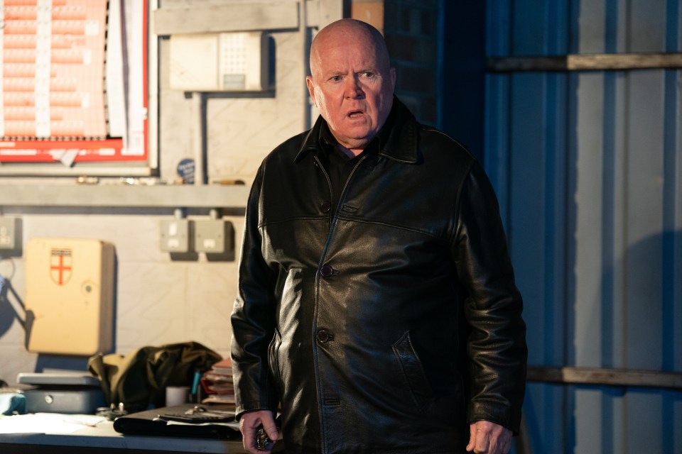 Phil Mitchell from EastEnders in a black leather jacket.