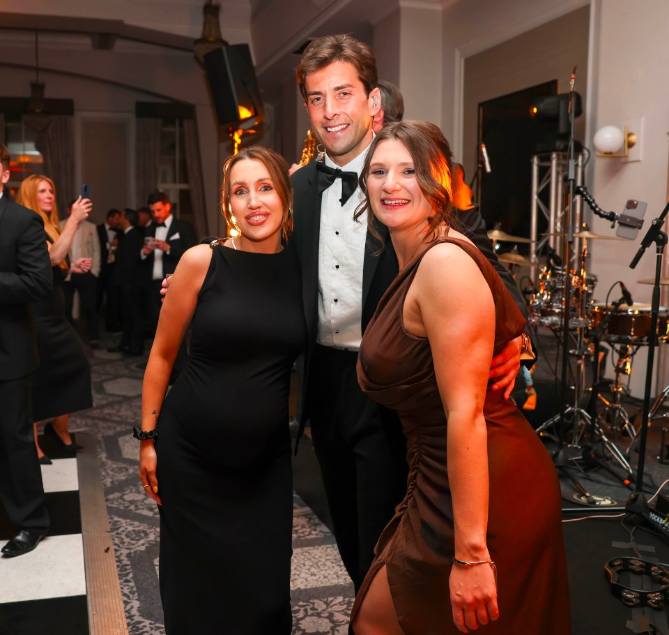 Three people posing for a photo at a charity event.