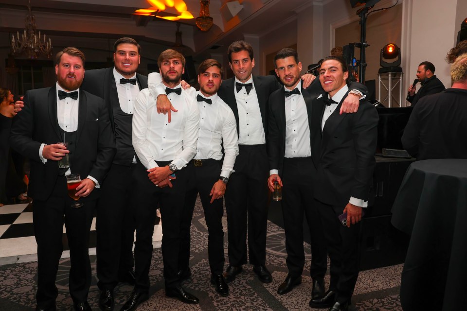 Group of men in tuxedos at a charity event.