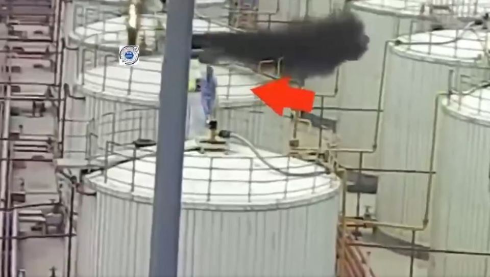 Black smoke billowing from industrial equipment.