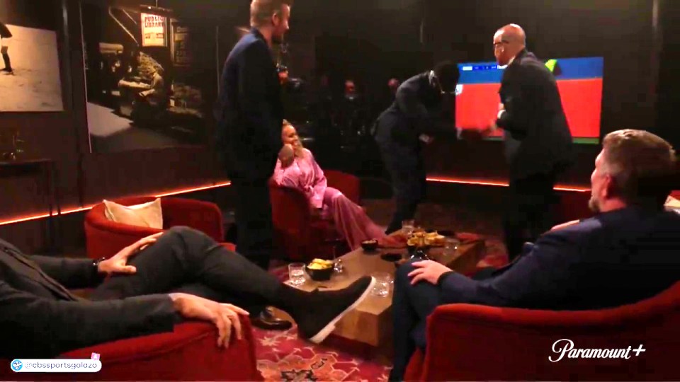 Micah Richards sitting on David Beckham's lap during a show.