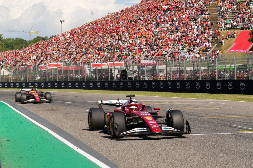 Charles Leclerc's Ferrari leading another Formula 1 car during a race.