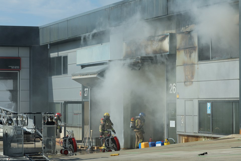 Firefighters at the site of a burning building.