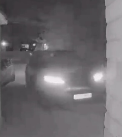Night vision security camera footage of a car being stolen.
