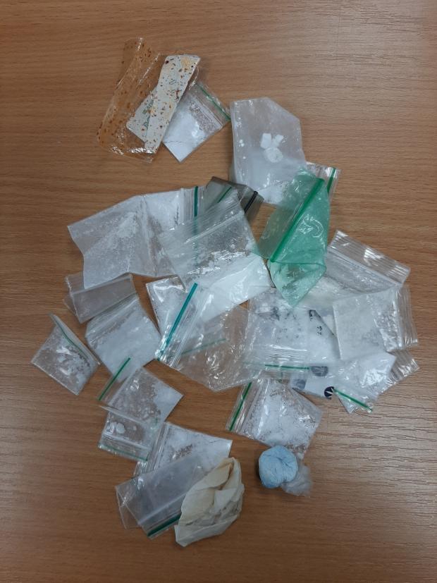 Seized drugs: cocaine, ketamine, and cannabis in small bags.