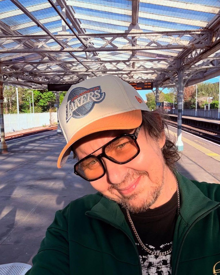 Matt King, known for his role as Super Hans in Peep Show, wearing a Los Angeles Lakers baseball cap.