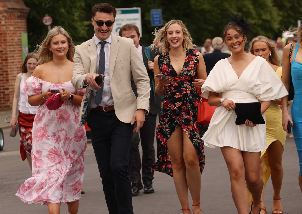 Racegoers walking and smiling.