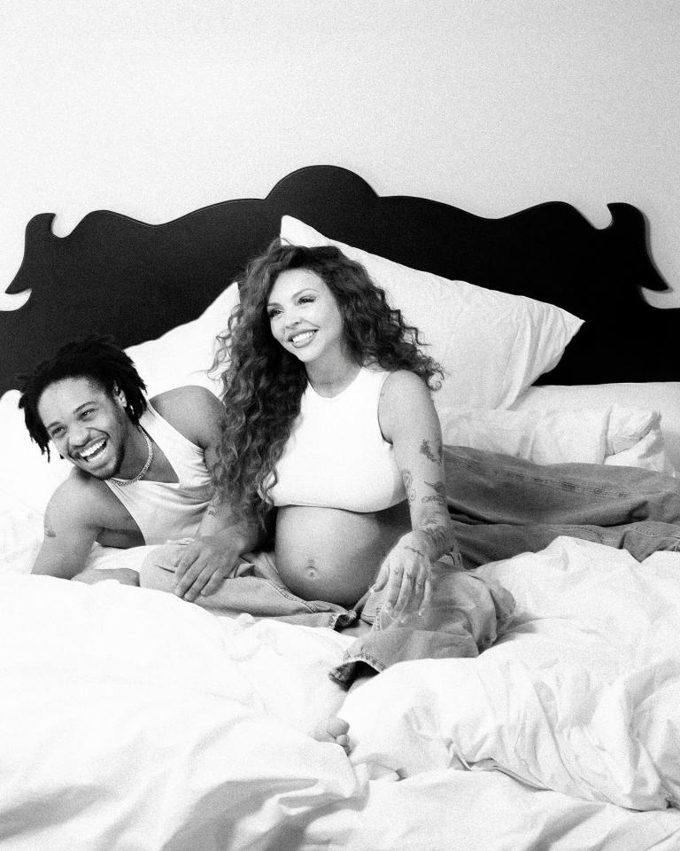 Black and white photo of a pregnant woman and a man lying in bed.