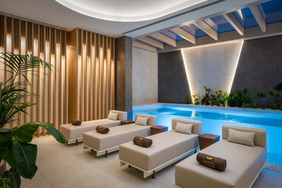 Spa area with lounge chairs and indoor pool at the Hyatt Regency Lisbon.