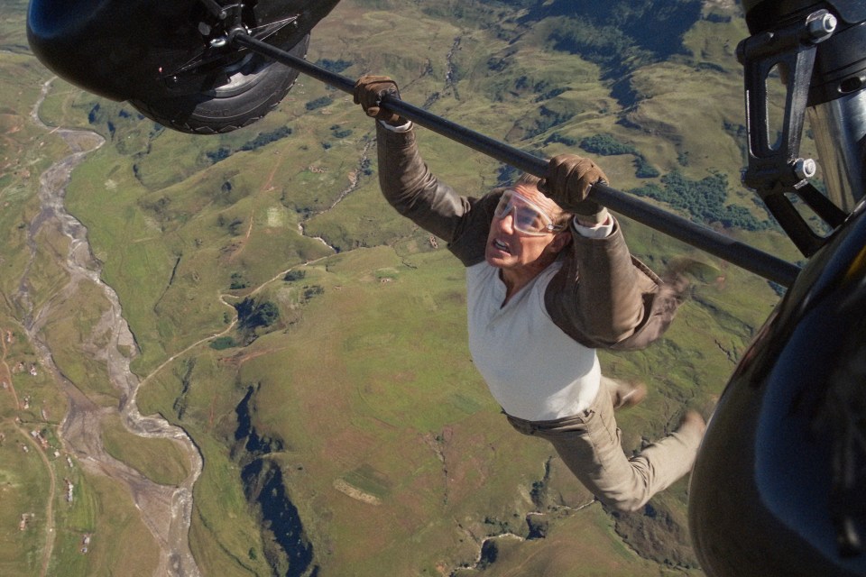 Tom Cruise hanging from a helicopter in Mission: Impossible - Dead Reckoning.