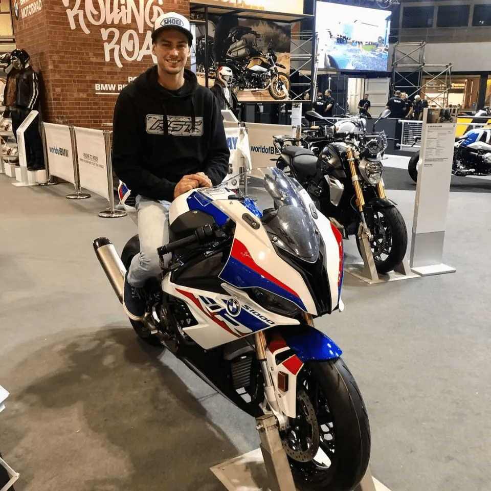 Man sitting on a BMW S1000RR motorcycle.