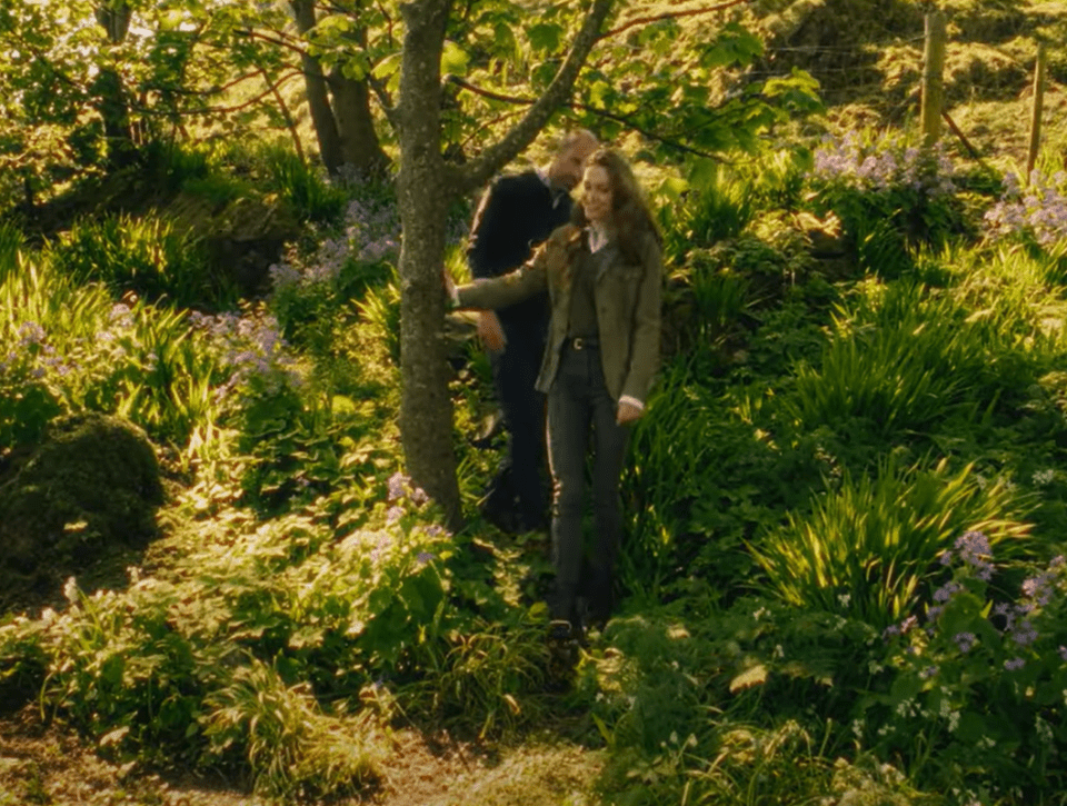 Couple standing in a lush garden.