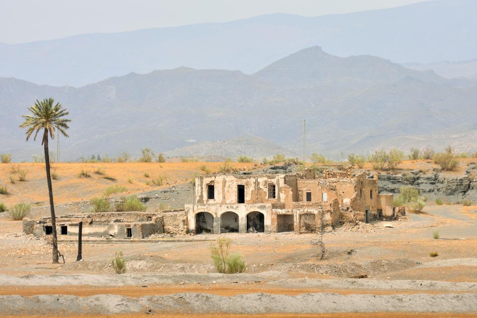 Ruins of a building in a desert landscape.