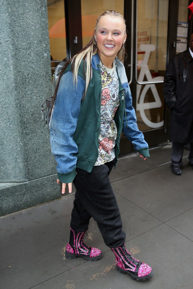 JoJo Siwa smiling in the rain in New York City.