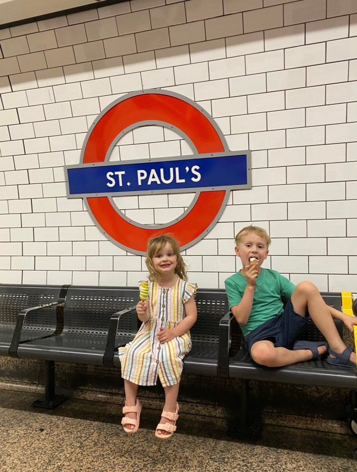 Two children eating ice cream at St. Paul's tube station.