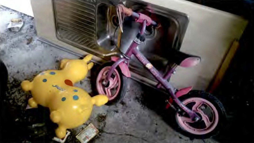 Children's toys and bicycle found at a crime scene.