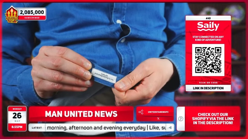 Person holding up a shirt tag that says "Carlos everything's coming my way," with Man United News graphic overlay.