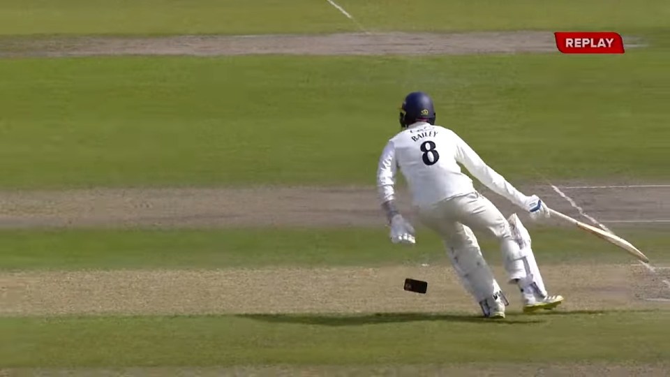 Cricket player dropping his phone while running.