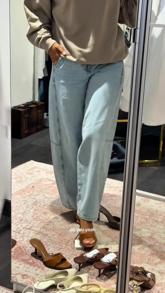 Person trying on shoes in a dressing room.