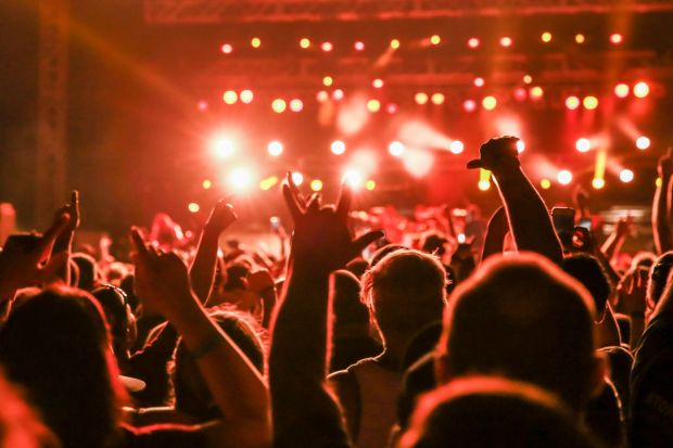 An image collage containing 1 images, Image 1 shows Concert crowd with arms raised