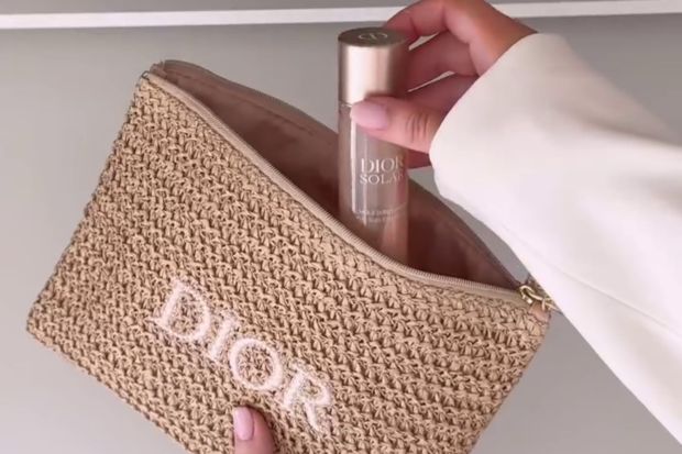 An image collage containing 1 images, Image 1 shows Person placing Dior sunscreen in a Dior raffia clutch