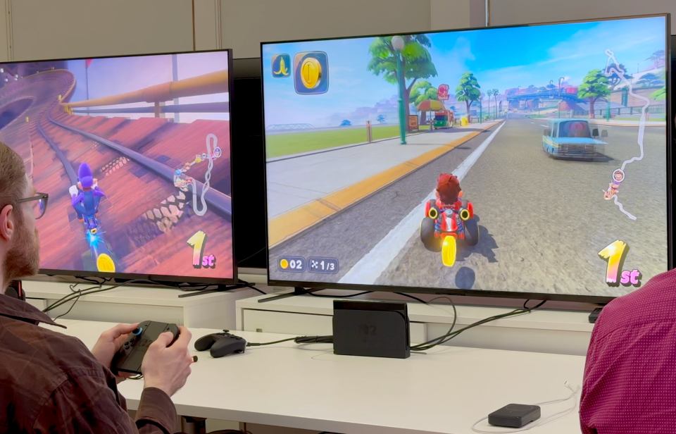 Two people playing a racing video game.