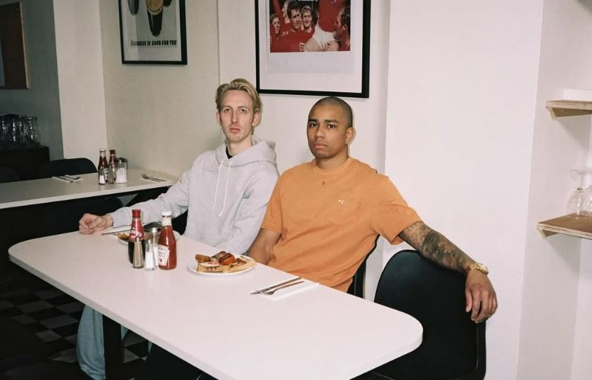 Two men sitting at a diner booth.
