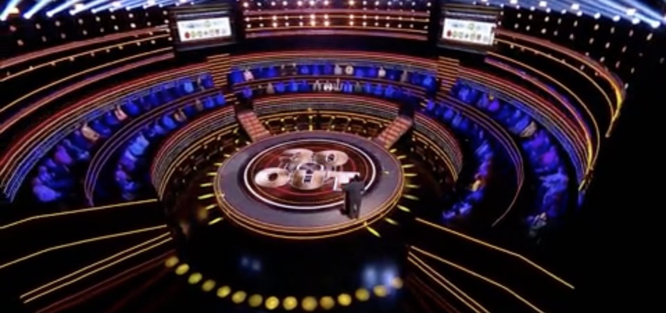 Overhead view of the set for the game show "The 1% Club," featuring a circular stage and audience seating.